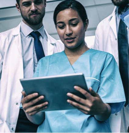 Doctors looking at a tablet